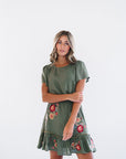 Mini green dress with short sleeves and floral details